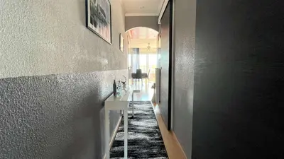 a hallway of a home with a black and white carpet at Appartement deux pièces Port La Nouvelle PN020-031 in Port-la-Nouvelle