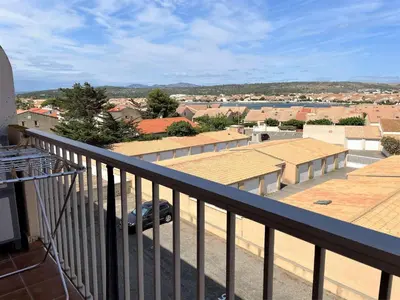 a balcony with a view of a city at Appartement deux pièces Port La Nouvelle PN020-031 in Port-la-Nouvelle