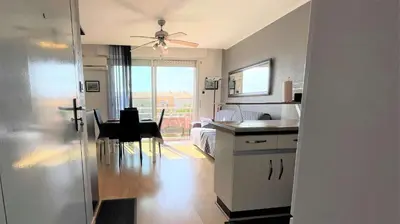 a room with a kitchen and a dining room with a table at Appartement deux pièces Port La Nouvelle PN020-031 in Port-la-Nouvelle