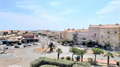 a street in a town with cars on the road at Appartement deux pièces Port La Nouvelle PN020-031 in Port-la-Nouvelle