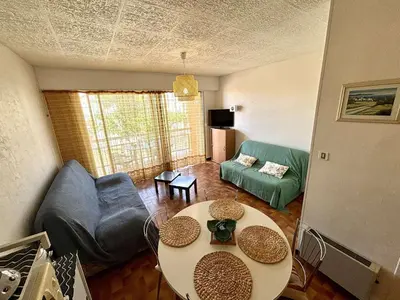 a living room with a couch and a table at Studio 3 couchages PORT LA NOUVELLE PN040-004 in Port-la-Nouvelle
