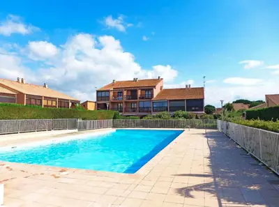 a swimming pool in front of a house at Maison 2 pièces cabine - Gruissan GN020-084 in Gruissan