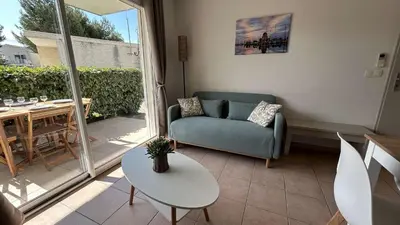 a living room with a couch and a table at Appartement 2 pièces climatisé proche du port GN190-015 in Gruissan