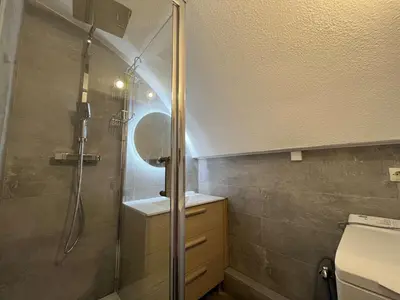 a bathroom with a shower and a sink and a toilet at Appartement dernier étage avec terrasse vue port GN400-028 in Gruissan