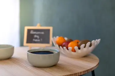 a table with bowls of fruit and a chalkboard at Le Jasmin - Netflix Inclus in Narbonne