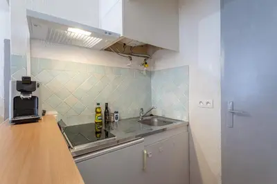 a small kitchen with a sink and a counter at L'Ocre - Netflix Inclus in Narbonne