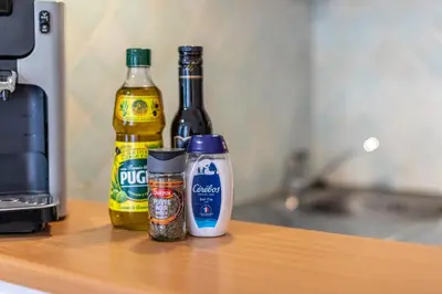 a counter with two bottles of beer and spices at L'Ocre - Netflix Inclus in Narbonne