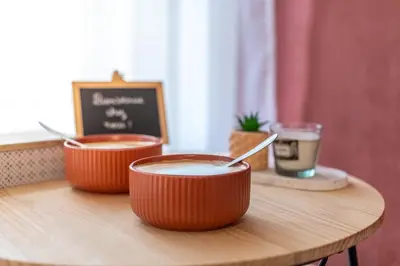 two bowls of coffee sitting on a wooden table at L'Ocre - Netflix Inclus in Narbonne