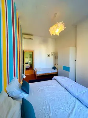 a bedroom with two beds and a room with a bedsenalsenalsenal at La Maison Cardau in Névian