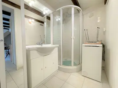 a white bathroom with a shower and a sink at Petit pavillon climatisé avec parking privé Grazel GN490-055 in Gruissan