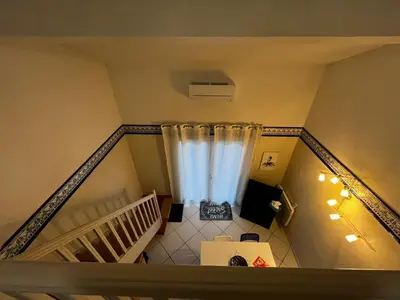 an overhead view of a staircase with a curtain at Maison de vacances à la mer in Port-la-Nouvelle
