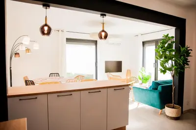 a dining room with a table and chairs at Maison Nomade piscine privée, parking et clim in Carcassonne