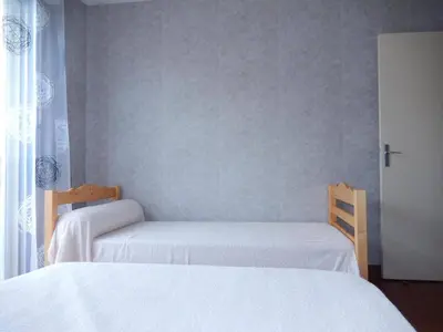 two beds in a bedroom with white sheets at Appartement 3 pièces PORT LA NOUVELLE PN050-015 in Port-la-Nouvelle
