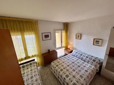 a hotel room with a bed and a window at Appartement 2 pièces PORT LA NOUVELLE PN070-002 in Port-la-Nouvelle