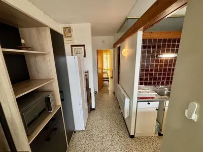 a small kitchen with a refrigerator in a room at Appartement 2 pièces PORT LA NOUVELLE PN070-002 in Port-la-Nouvelle