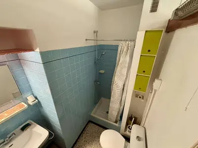 a small bathroom with a toilet and a shower at Appartement 2 pièces PORT LA NOUVELLE PN070-002 in Port-la-Nouvelle