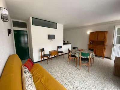 a living room with a couch and a table and chairs at Maison 3 pièces PORT LA NOUVELLE PN080-006 in Port-la-Nouvelle