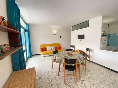 a living room with a table and a couch at Maison 3 pièces PORT LA NOUVELLE PN080-006 in Port-la-Nouvelle
