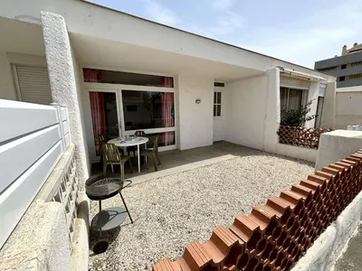 a balcony of a house with a table and chairs at Maison 3 pièces PORT LA NOUVELLE PN080-006 in Port-la-Nouvelle