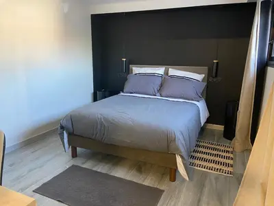 a bedroom with a large bed with purple pillows at Chambres chez l'habitant in Salles-d'Aude