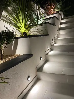 a staircase with lights on the side of a building at Chambres chez l'habitant in Salles-d'Aude