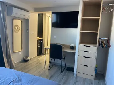 a bedroom with a desk and a bedroom with a bed at Chambres chez l'habitant in Salles-d'Aude