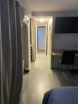 a room with a bed and a table and a desk at Chambres chez l'habitant in Salles-d'Aude