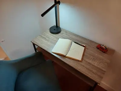 a desk with a book and a lamp and a car on it at Appartement vue panoramique in Carcassonne