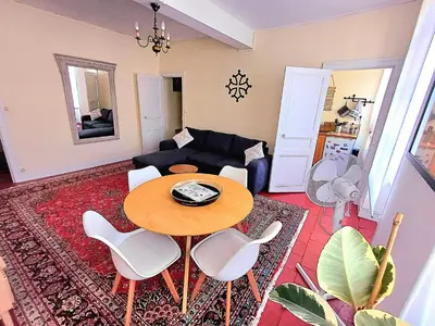a living room with a table and a couch at Appartement vue panoramique in Carcassonne