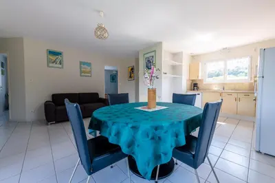a living room with a table with a blue table cloth at Gîte L'Orée du Lac in Carcassonne