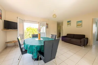 a living room with a table and a couch at Gîte L'Orée du Lac in Carcassonne