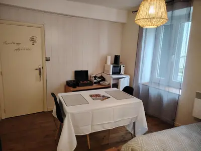 a small room with a white table and a microwave at Le Coeur de Négrin in Mazamet