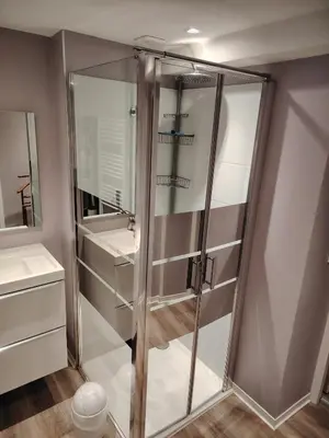 a shower with glass doors in a bathroom at Le Coeur de Négrin in Mazamet
