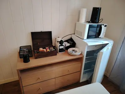 a room with a microwave on top of a dresser at Le Coeur de Négrin in Mazamet