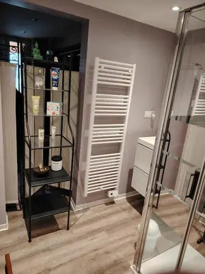 a room with a black book shelf and a mirror at Le Coeur de Négrin in Mazamet