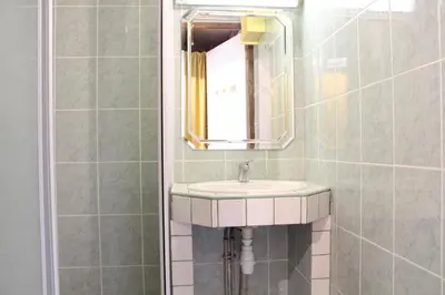a bathroom with a sink and a mirror at Appartement Studio mezzanine PORT LA NOUVELLE PN290-103 in Port-la-Nouvelle