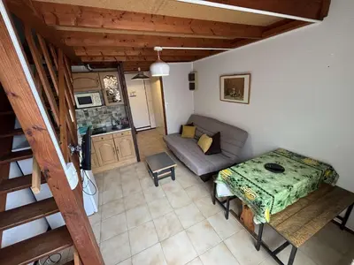 a small living room with a couch and a table at Appartement Studio mezzanine PORT LA NOUVELLE PN290-103 in Port-la-Nouvelle