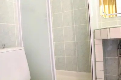 a shower stall in a bathroom with a toilet at Appartement Studio mezzanine PORT LA NOUVELLE PN290-103 in Port-la-Nouvelle