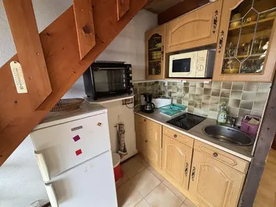 a kitchen with a white refrigerator and a sink at Appartement Studio mezzanine PORT LA NOUVELLE PN290-103 in Port-la-Nouvelle