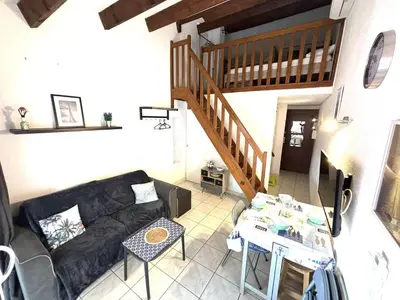 a living room with a couch and a table at Appartement studio Mezzanine Port la Nouvelle PN340-010 in Port-la-Nouvelle