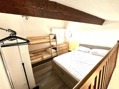 a bedroom with a bed and a crib in it at Appartement studio Mezzanine Port la Nouvelle PN340-010 in Port-la-Nouvelle