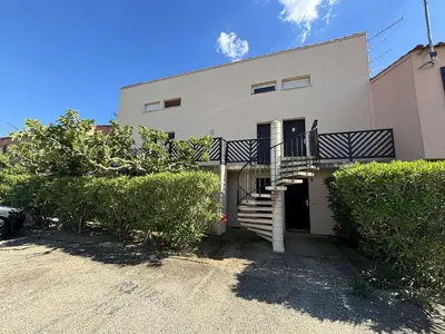 a white house with a staircase in front of it at Appartement studio Mezzanine Port la Nouvelle PN340-010 in Port-la-Nouvelle