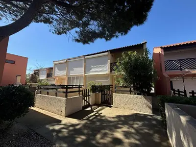 a building with a fence in front of it at Appartement studio Mezzanine Port la Nouvelle PN340-010 in Port-la-Nouvelle
