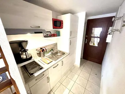 a small kitchen with a sink and a stove at Appartement studio Mezzanine Port la Nouvelle PN340-010 in Port-la-Nouvelle