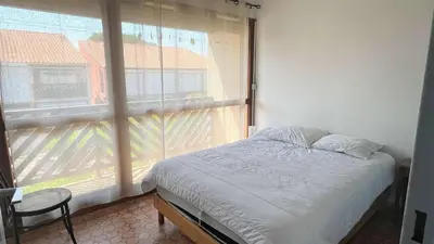 a bedroom with a bed and a large window at APPARTEMENT 3 pieces PORT LA NOUVELLE PN340-126 in Port-la-Nouvelle