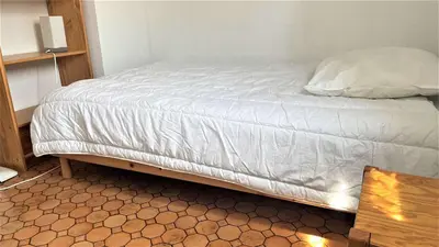 an unmade bed in a small room with at APPARTEMENT 3 pieces PORT LA NOUVELLE PN340-126 in Port-la-Nouvelle