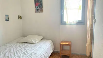 a bedroom with a bed and a window and a table at APPARTEMENT 3 pieces PORT LA NOUVELLE PN340-126 in Port-la-Nouvelle