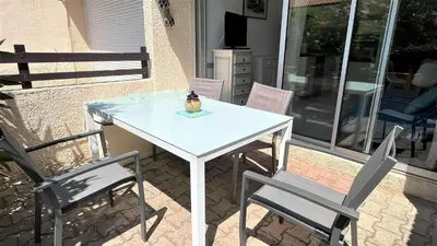 a white table and chairs on a patio at APPARTEMENT 3 pieces PORT LA NOUVELLE PN340-126 in Port-la-Nouvelle