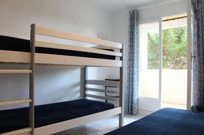 a bedroom with two bunk beds and a window at Maison 3 pièces mezzanine PORT LA NOUVELLE PN360-013 in Port-la-Nouvelle