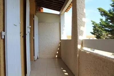 an empty hallway of a building with a window at Maison 3 pièces mezzanine PORT LA NOUVELLE PN360-013 in Port-la-Nouvelle